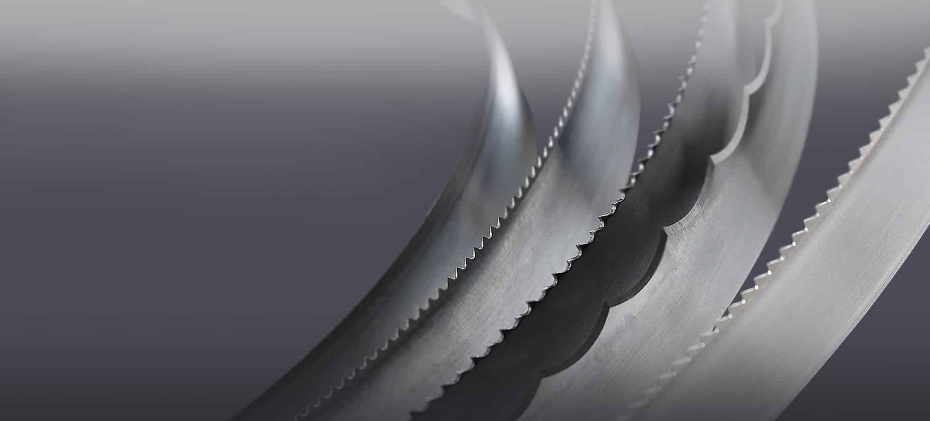 Simmons' foam cutting blades curve and catch the light against a dark gray background.